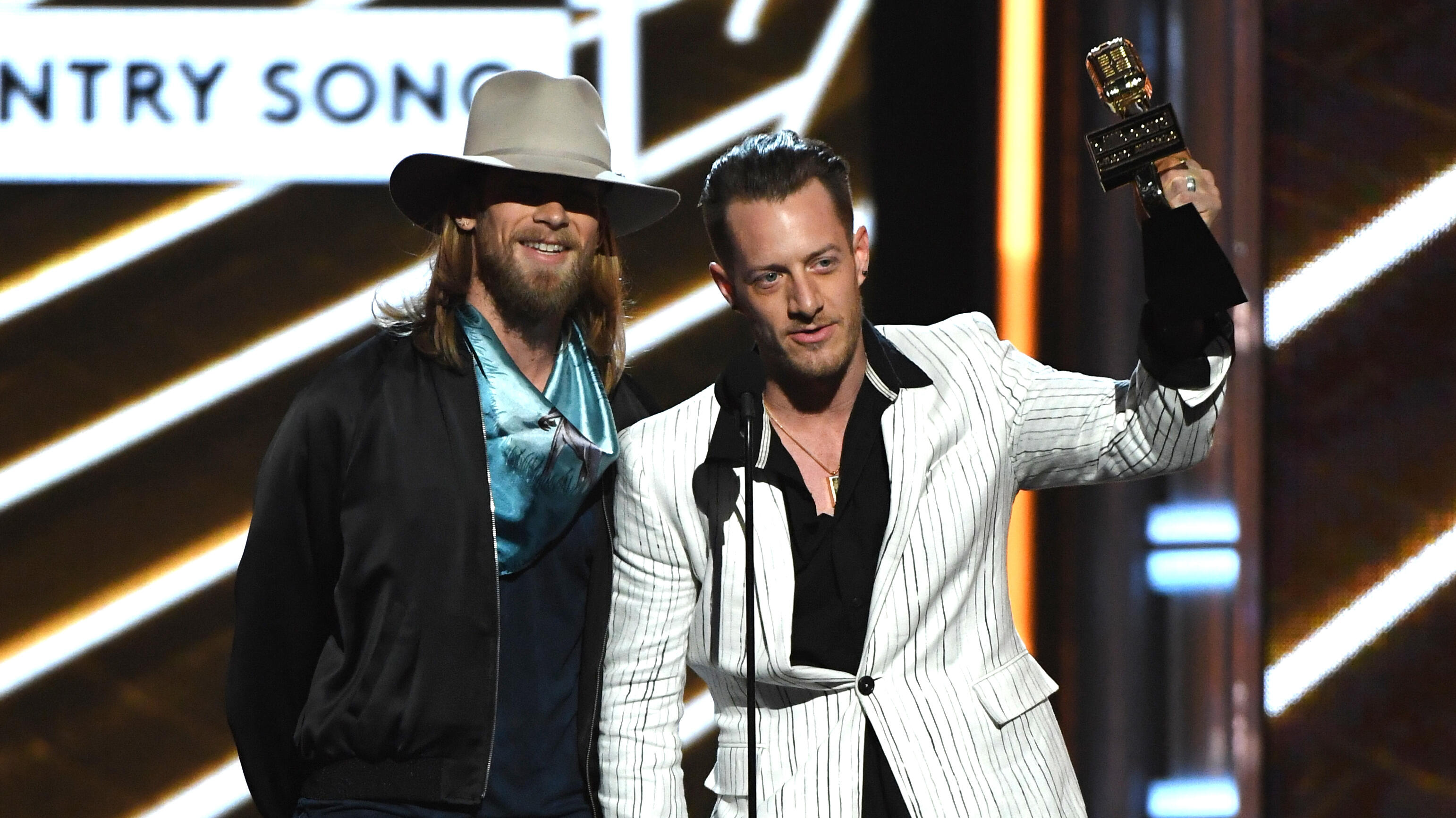 LAS VEGAS, NV - MAY 21:  Musicians Brian Kelley (L) and Tyler Hubbard of Florida Georgia Line accept Top Country Song for 'H.O.L.Y.' onstage during the 2017 Billboard Music Awards at T-Mobile Arena on May 21, 2017 in Las Vegas, Nevada.  (Photo by Ethan Mi