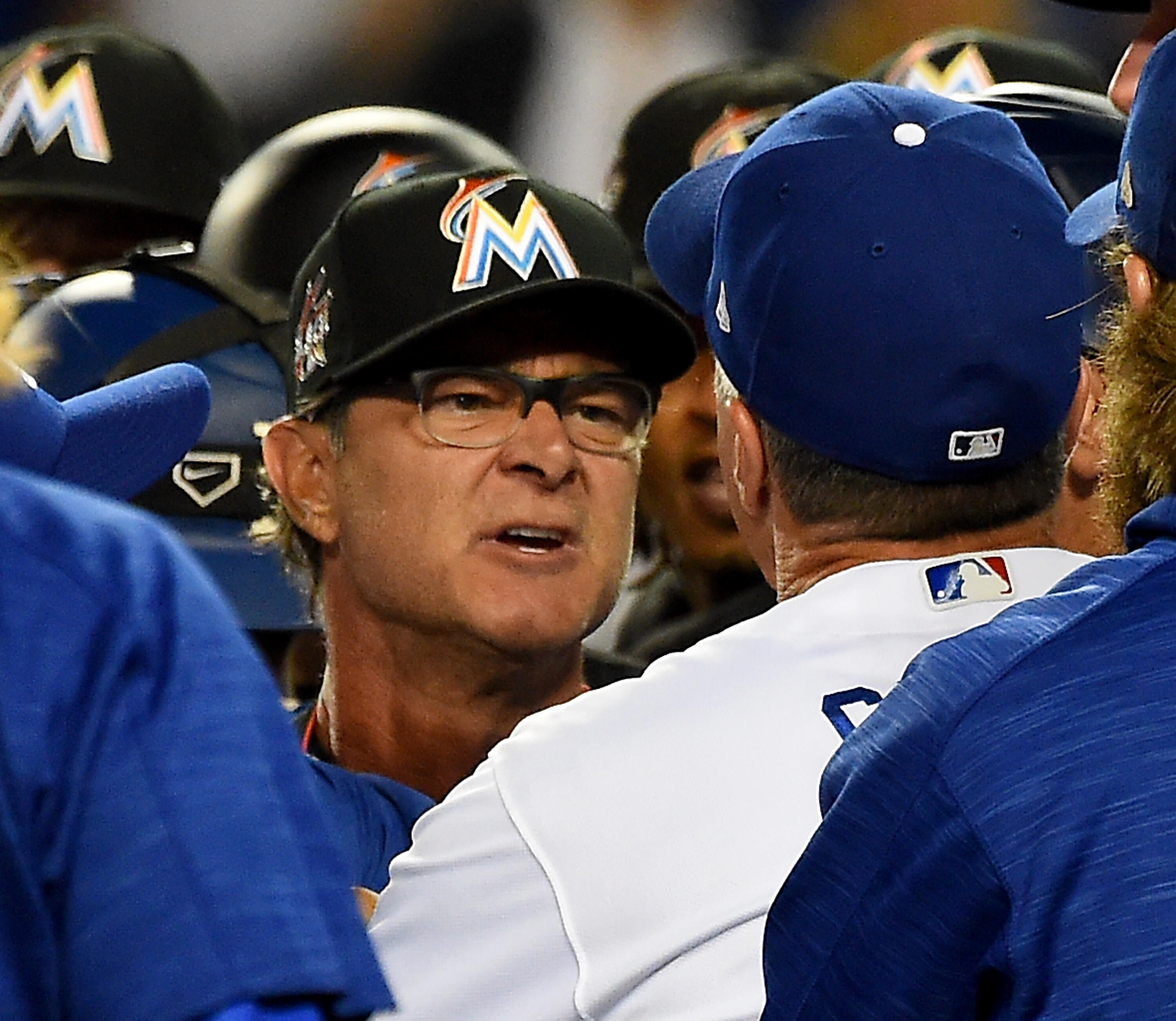 LOS ANGELES, CA - MAY 19:  Don Mattingly #8, manager of the Miami Marlins and Bob Geren #8, bench coach of the Los Angeles Dodgers exchange words after benches cleared in the eighth inning at Dodger Stadium on May 19, 2017 in Los Angeles, California. Both