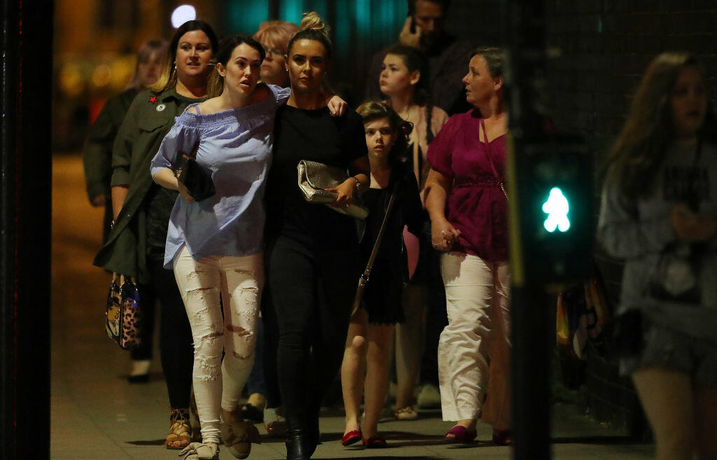 MANCHESTER, ENGLAND - MAY 23:  Police escort members of the public from the Manchester Arena on May 23, 2017 in Manchester, England.  There have been reports of explosions at Manchester Arena where Ariana Grande had performed this evening.  Greater Manchester Police have have confirmed there are fatalities and warned people to stay away from the area. (Photo by Christopher Furlong/Getty Images)
