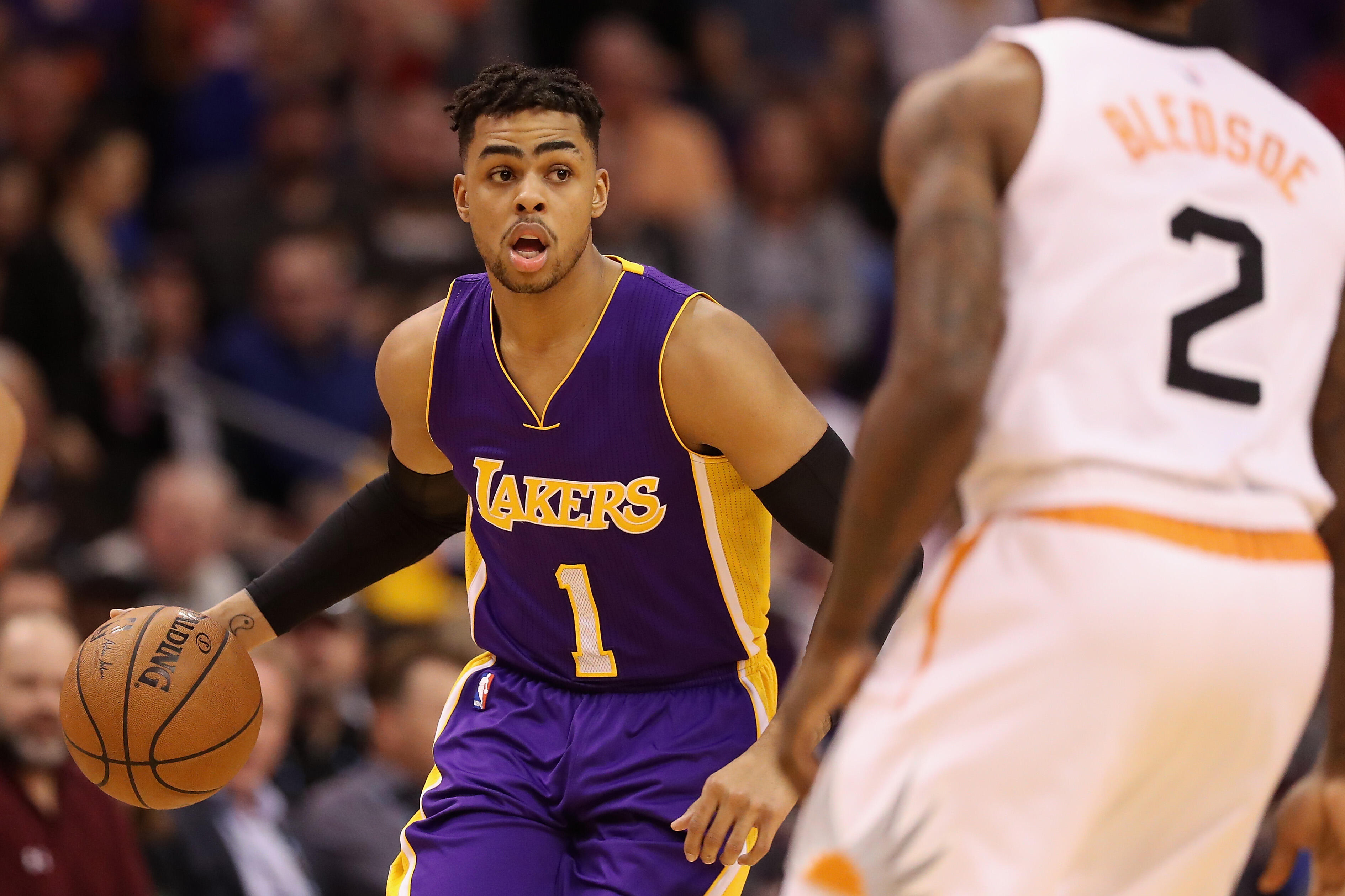 PHOENIX, AZ - FEBRUARY 15:  D'Angelo Russell #1 of the Los Angeles Lakers moves the ball upcourt against Eric Bledsoe #2 of the Phoenix Suns during the first half of the NBA game at Talking Stick Resort Arena on February 15, 2017 in Phoenix, Arizona. The 