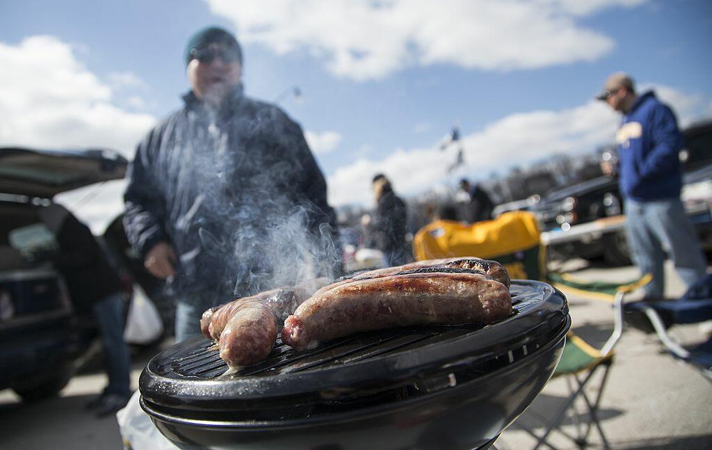 MILWAUKEE, WI - APRIL 1: A fan cooks brats on the grill before the game between the Milwaukee Brewers and Colorado Rockies on opening day at Miller Park on April 1, 2013 in Milwaukee, Wisconsin.  (Photo by Tom Lynn/Getty Images)