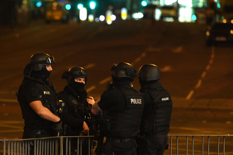 Armed police stand guard at the scene of a suspected terrorist attack during a pop concert by US star Ariana Grande in Manchester, northwest England on May 23, 2017. / AFP PHOTO / Paul ELLIS        (Photo credit should read PAUL ELLIS/AFP/Getty Images)