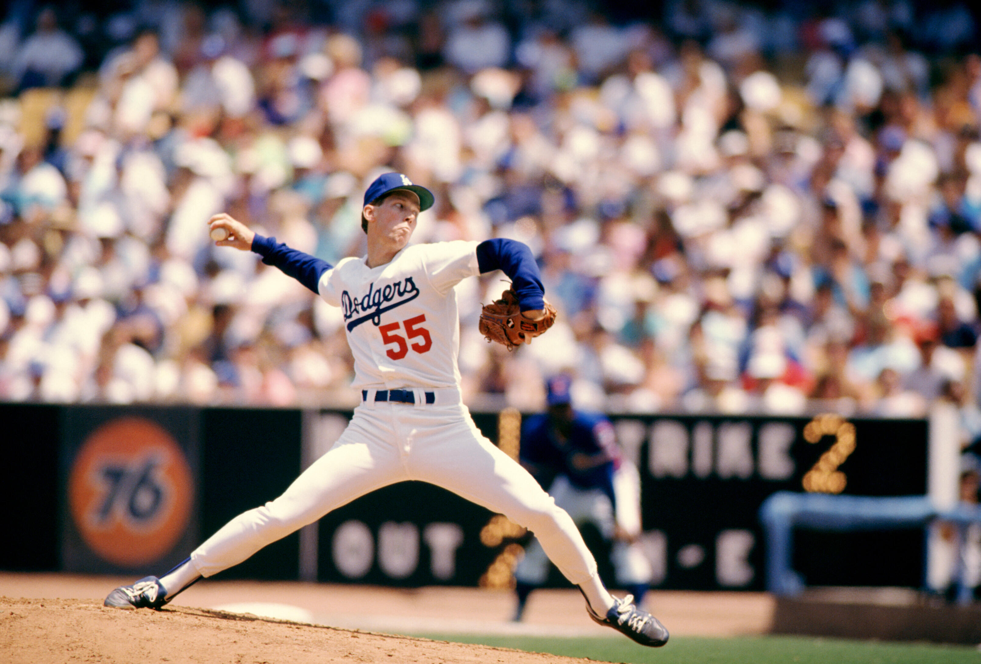 LOS ANGELES, CA - 1989:  Pitcher Orel Hersheiser #55 of the Los Angeles Dodgers throws during an MLB game against the New York Mets circa 1989 at Dodger Stadium in Los Angeles, California.  (Photo by Mike Powell/Getty Images)