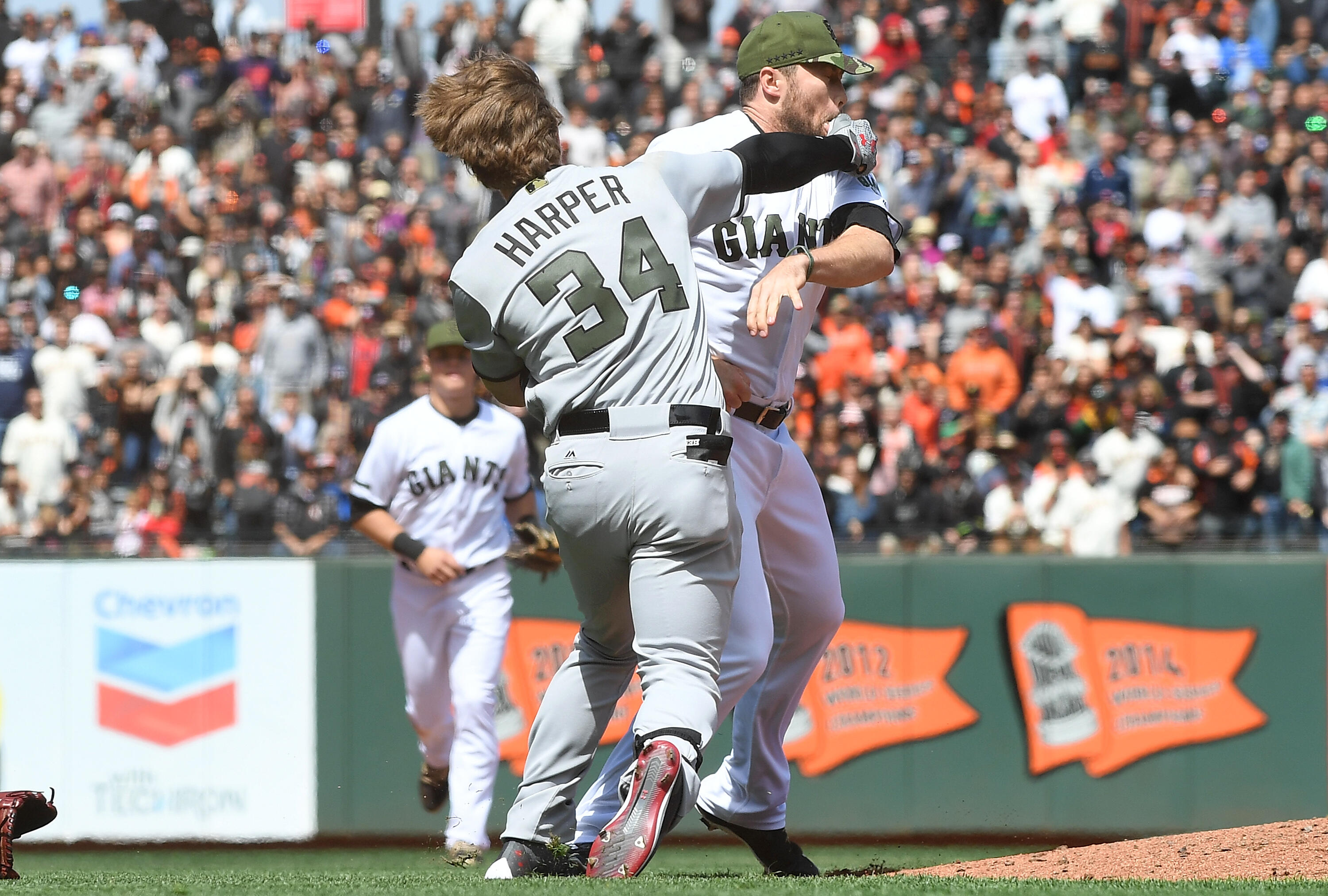 SAN FRANCISCO, CA - MAY 29:  Bryce Harper #34 of the Washington Nationals and Hunter Strickland #60 of the San Francisco Giants throw punches at one another after Strickland hit Harper with a pitch in the top of the eighth inning at AT&T Park on May 29, 2