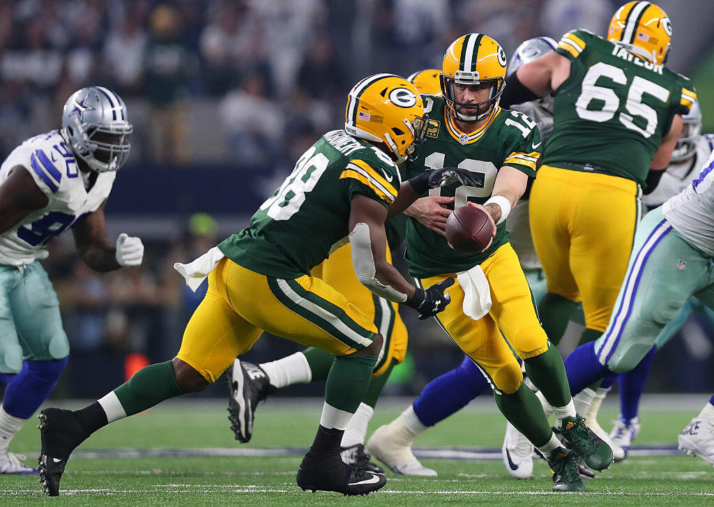 ARLINGTON, TX - JANUARY 15:  Aaron Rodgers #12 of the Green Bay Packers hands off to Ty Montgomery #88 during the third quarter in the NFC Divisional Playoff game at AT&T Stadium on January 15, 2017 in Arlington, Texas.  (Photo by Tom Pennington/Getty Images)
