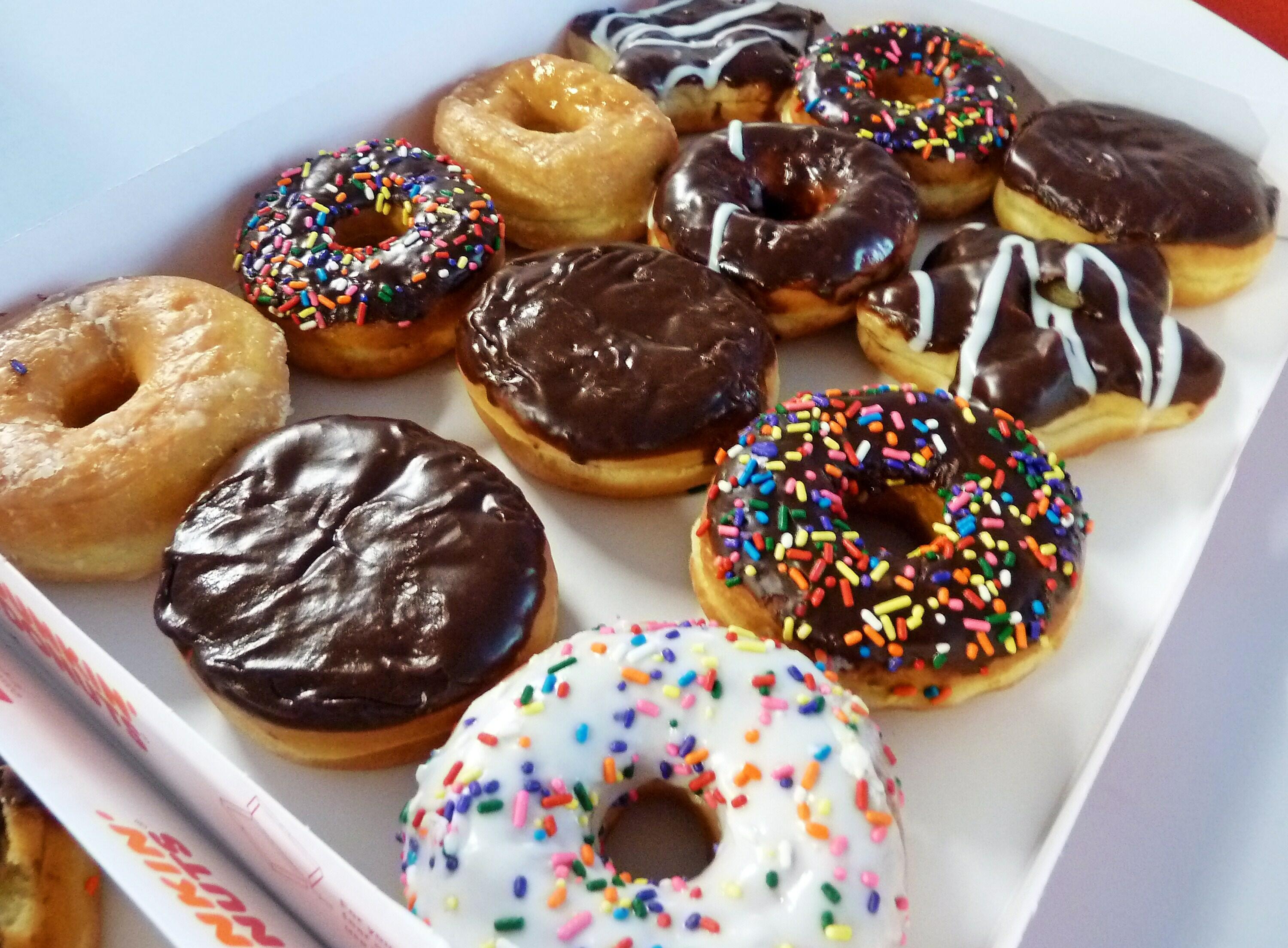 An assortment of ring doughnuts and filled doughnuts, glazed doughnuts and powdered doughnuts is seen in a paper box in Washington, DC June 5, 2015. The first Friday in June is 