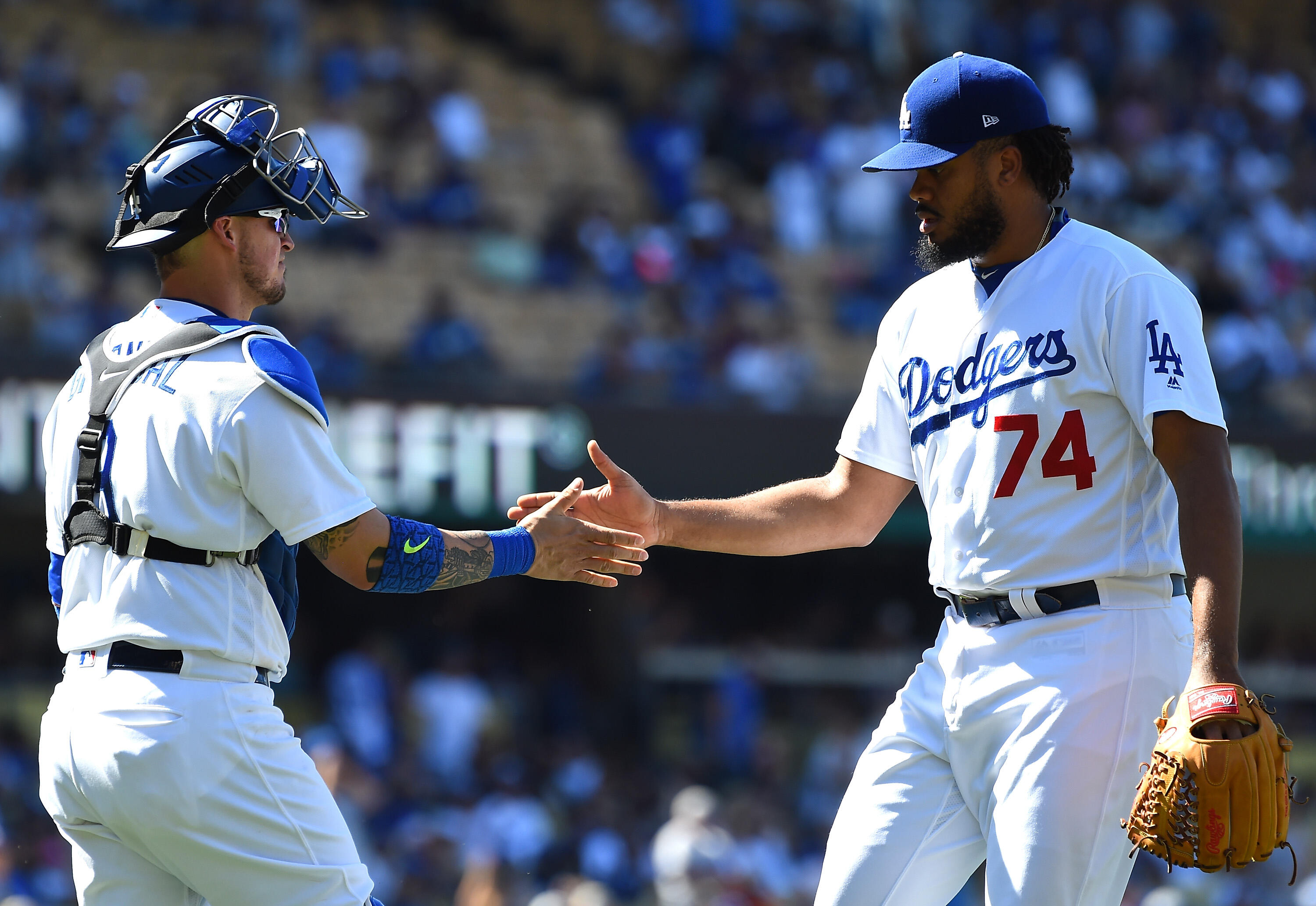LOS ANGELES, CA - MAY 21: Kenley Jansen #74 of the Los Angeles Dodgers shakes hands with Yasmani Grandal #9 of the Los Angeles Dodgers after a save in the ninth inning against the Miami Marlins at Dodger Stadium on May 21, 2017 in Los Angeles, California.