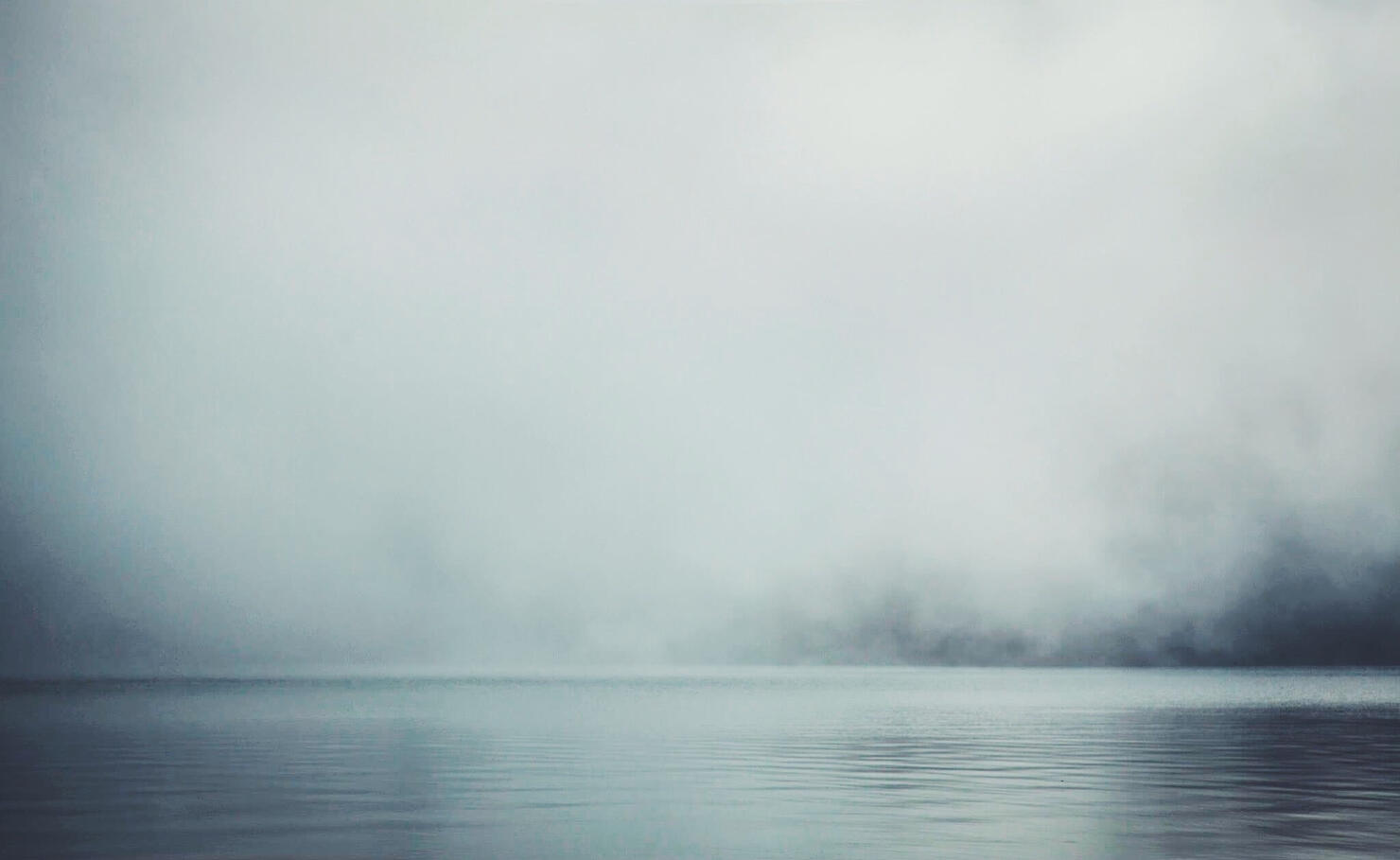 Scenic View Of Lake Against Sky During Foggy Weather