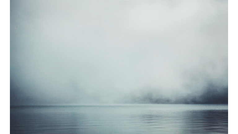 Scenic View Of Lake Against Sky During Foggy Weather