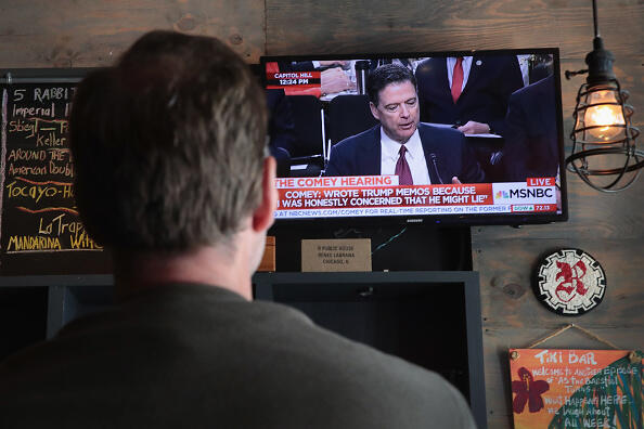 CHICAGO, IL - JUNE 08: Customers at R Public House watch as former FBI Director James Comey testifies before the Senate intelligence committee on June 8, 2017 in Chicago, Illinois. The bar opened five hours early today to offer its customers a place to gather, watch and discuss the testimony.  (Photo by Scott Olson/Getty Images)