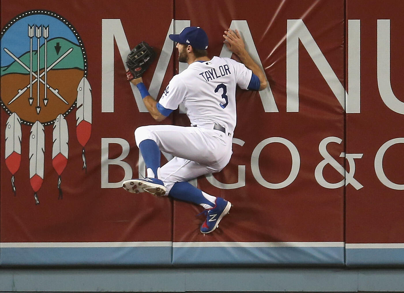 LOS ANGELES, CA - JUNE 10:  Center fielder Chris Taylor #3 of the Los Angeles Dodgers crashes into the wall after making a leaping catch on a ball hit by Joey Votto of the Cincinnati Reds in the sixth inning at Dodger Stadium on June 10, 2017 in Los Angel
