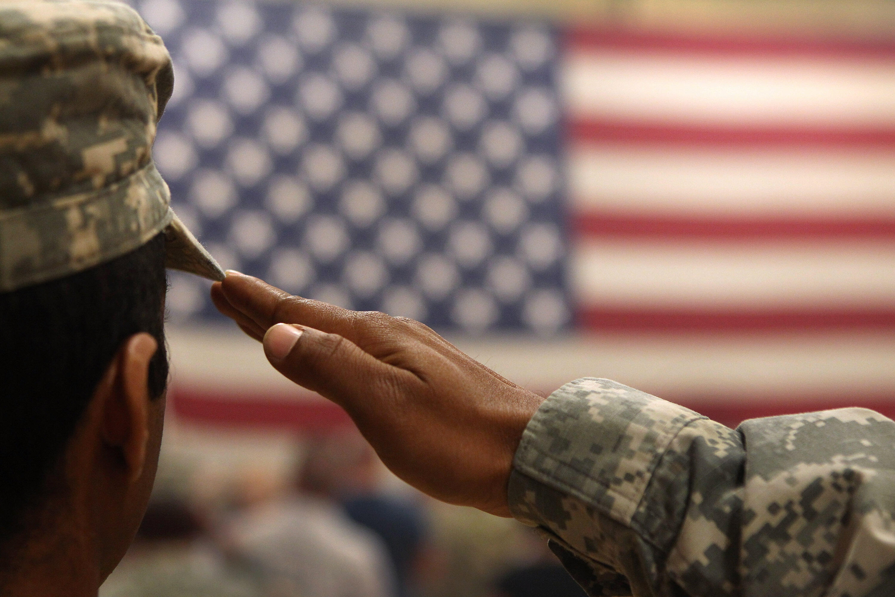 FORT CARSON, CO - JUNE 15:  A soldier salutes the flag during a welcome home ceremony for troops arriving from Afghanistan on June 15, 2011 to Fort Carson, Colorado. More than 500 soldiers from the 1st Brigade Combat Team returned home following a year of