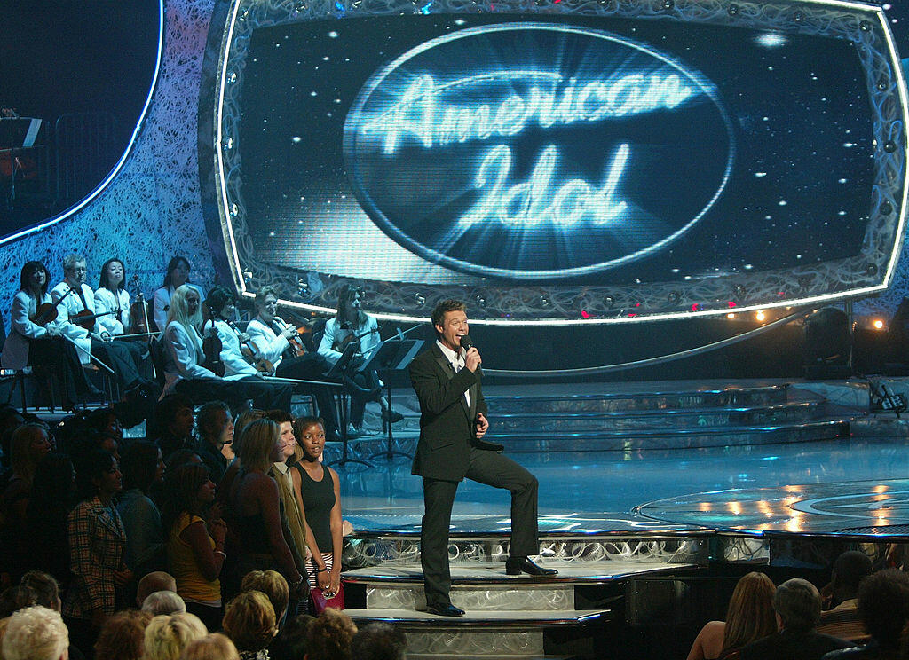 HOLLYWOOD - MAY 26:  Show host Ryan Seacrest speaks on stage at the American Idol Season Three Grand Finale at the Kodak Theatre May 26, 2004 in Hollywood, California.  (Photo by Frank Micelotta/Getty Images)  