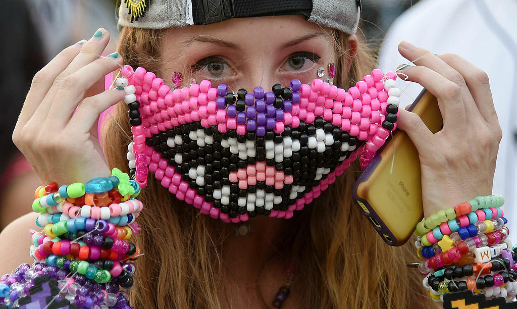 LAS VEGAS, NV - JUNE 21:  Mina Griffioen of Maryland puts on a beaded mask during the 18th annual Electric Daisy Carnival at Las Vegas Motor Speedway on June 21, 2014 in Las Vegas, Nevada.  (Photo by Ethan Miller/Getty Images)