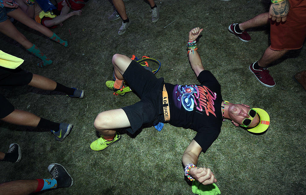 LAS VEGAS, NV - JUNE 22:  Dason Alverson of Idaho dances as he lies on the ground during a set by Henry Fong during the 18th annual Electric Daisy Carnival at Las Vegas Motor Speedway on June 22, 2014 in Las Vegas, Nevada.  (Photo by Ethan Miller/Getty Im