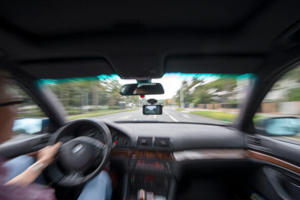 DARMSTADT, GERMANY - AUGUST 23:  In this photo illustration a small action camera hangs attached inside the windshield of a car on August 23, 2014 in Darmstadt, Germany. A German court recently confirmed a ban on the use of dashcams, claiming a continuous