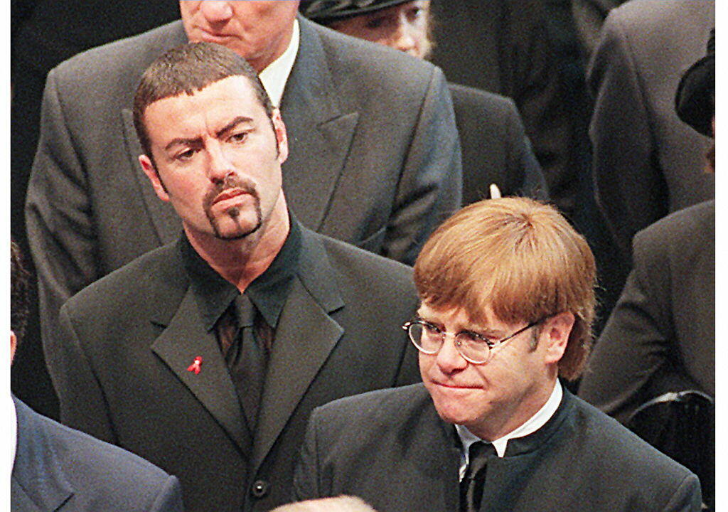 Pop stars George Michael (top) and Elton John leave Westminster Abbey after the funeral service 06 September of Diana Princess of Wales. The Princess was killed in a car crash in Paris 31 August. (Photo credit should read JOHNNY EGGITT/AFP/Getty Images)