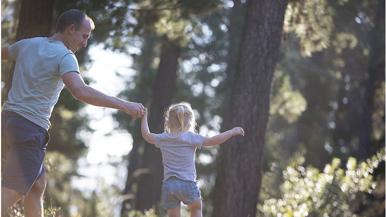 Father and daughter playing in the forest