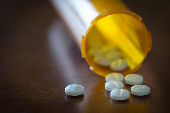 CANADA - 2016/01/21: Prescription pills in a yellow bottle over a wooden table with selective depth of field. (Photo by Roberto Machado Noa/LightRocket via Getty Images)