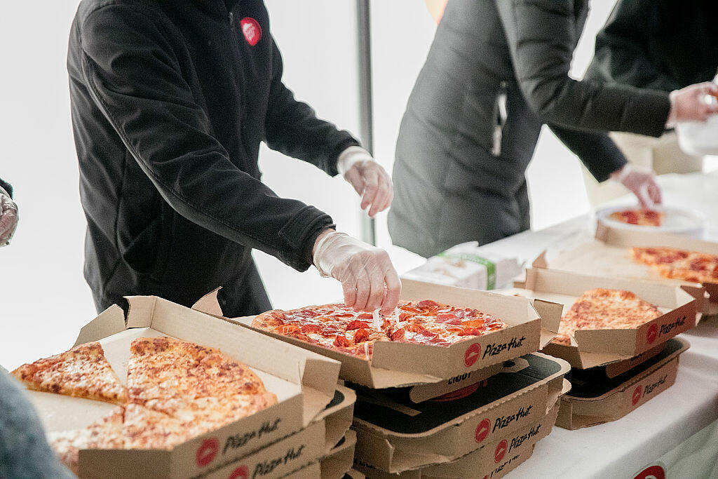 TERRE HAUTE, IN - NOVEMBER 19:  Cross country fans enjoy slices of Pizza Hut pizza at the Division I Cross Country Championship. Pizza Hut served more than 3,200 slices of pizza as the Official Pizza Partner of the NCAA on November 19, 2016 in Terre Haute, Indiana.  (Photo by Jeff Schear/Getty Images for Pizza Hut)