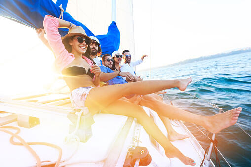 Happy sailing crew on sailboat