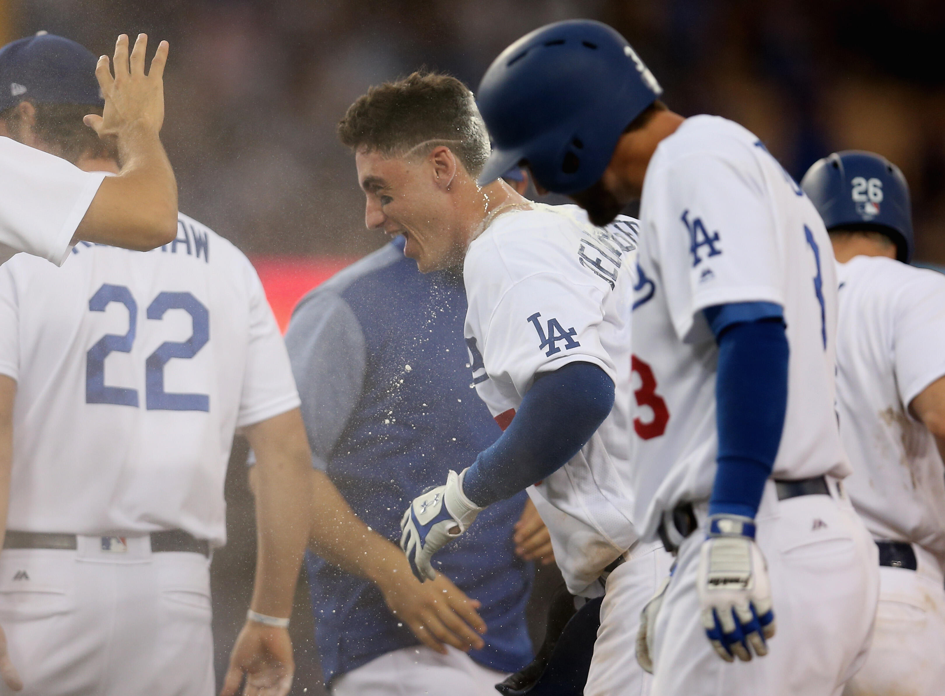 LOS ANGELES, CA - JULY 08:  Cody Bellinger #35 of the Los Angeles Dodgers is mobbed by teammates after drawing a bases loaded walk off walk in the tenth inning against the Kansas City Royals at Dodger Stadium on July 8, 2017 in Los Angeles, California.  T