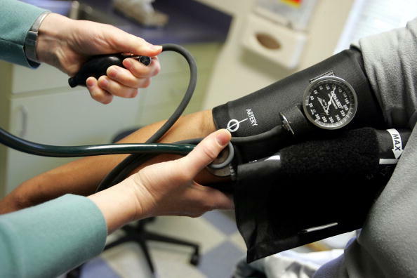 DORCHESTER, MA - APRIL 11:  Dr. Elizabeth Maziarka reads a blood pressure gauge during an examination of patient June Mendez at the Codman Square Health Center April 11, 2006 in Dorchester, Massachusetts. Massachusetts Governor Mitt Romney is scheduled to sign a health care reform bill April 12 that would make it the first state in the nation to require all its citizens have some form of health insurance.  (Photo by Joe Raedle/Getty Images)