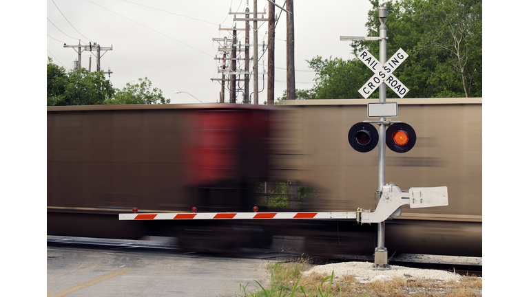 Moving Freight Train at Railroad Crossing