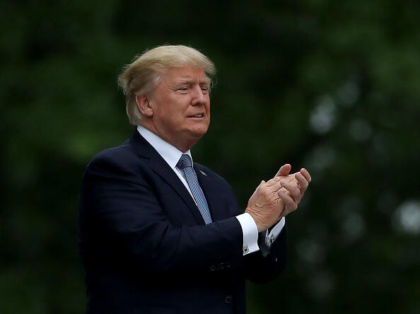 BEDMINSTER, NJ - JULY 14:  U.S. President Donald Trump acknowledges the patrons in the clubhouse as he leaves the U.S. Women's Open round two on July 14, 2017 at Trump National Golf Course in Bedminster, New Jersey.  (Photo by Elsa/Getty Images)