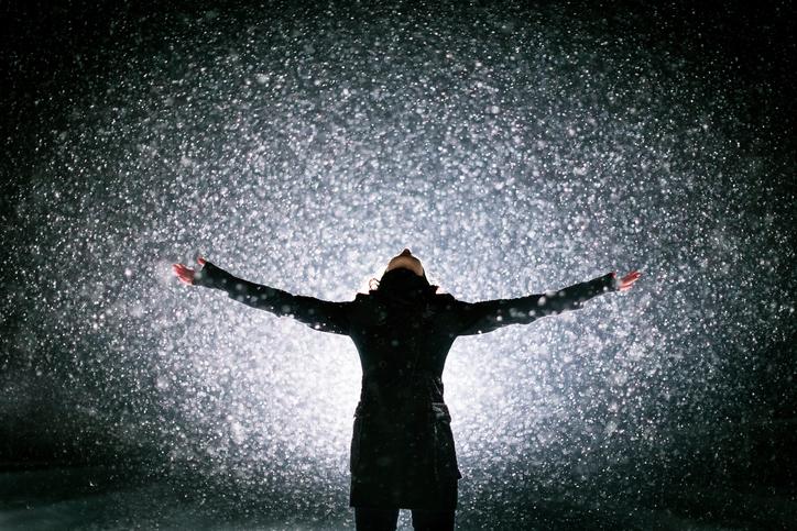 Young woman enjoying severe snow blizzard.