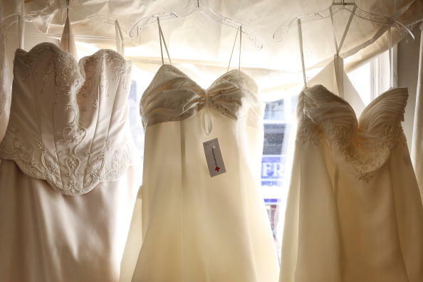 DORKING, ENGLAND - FEBRUARY 21: Second hand wedding dresses are displayed for sale at the Red Cross charity bridal shop on February 21, 2009 in Dorking, England. Sales of second bridal outfits and accesories have increased. The average wedding now costs �