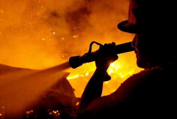 Filipino fire fighters extinguish a fire