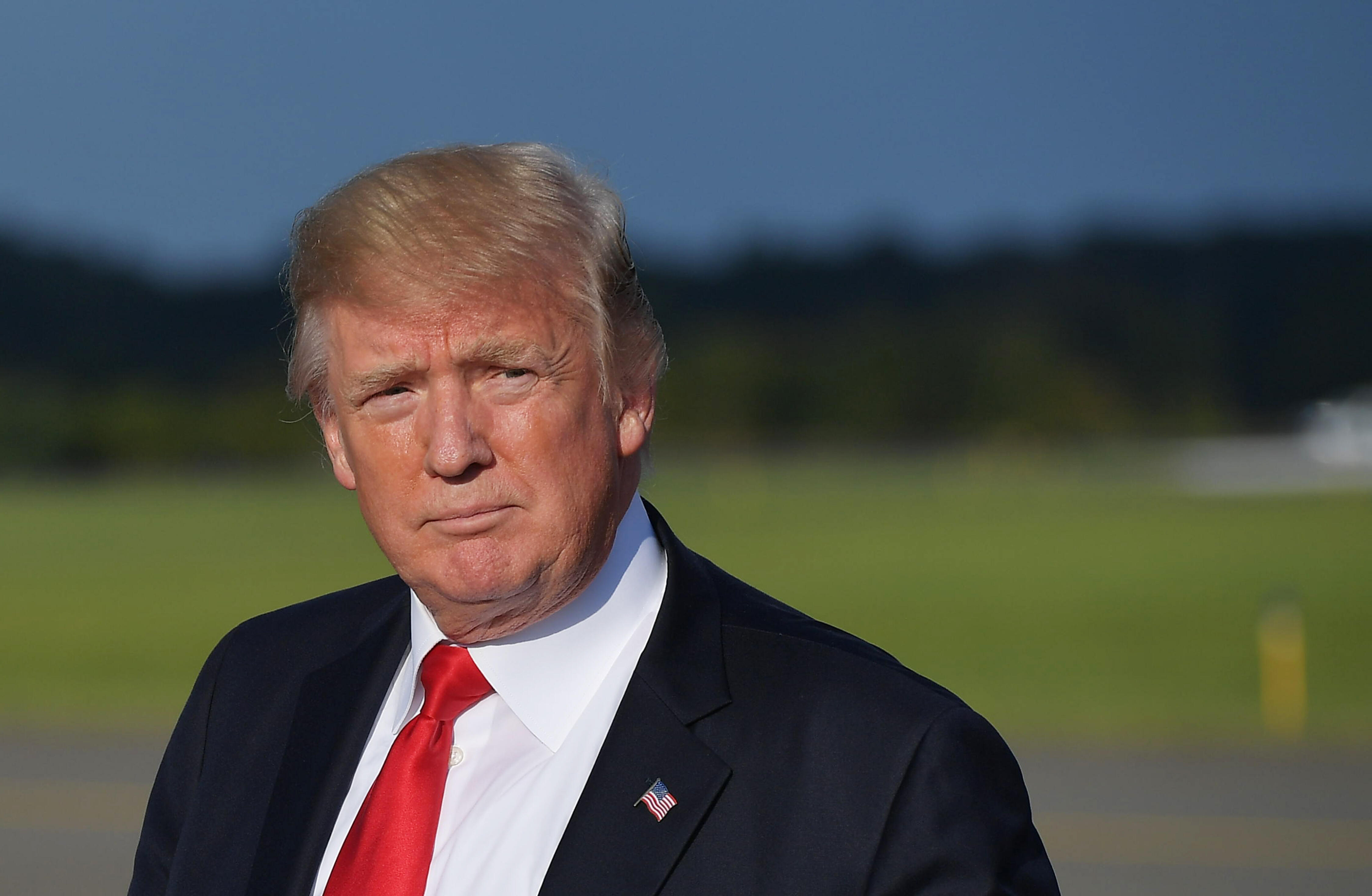 US President Donald Trump walks across the tarmac after stepping off Air Force One upon arrival at Morristown Municipal Airport in Morristown, New Jersey on September 15, 2017. Trump was headed to his Bedminster, New Jersey golf club to spend the weekend, as he prepares to address the UN General Assembly for the first time next week. / AFP PHOTO / MANDEL NGAN (Photo credit should read MANDEL NGAN/AFP/Getty Images)