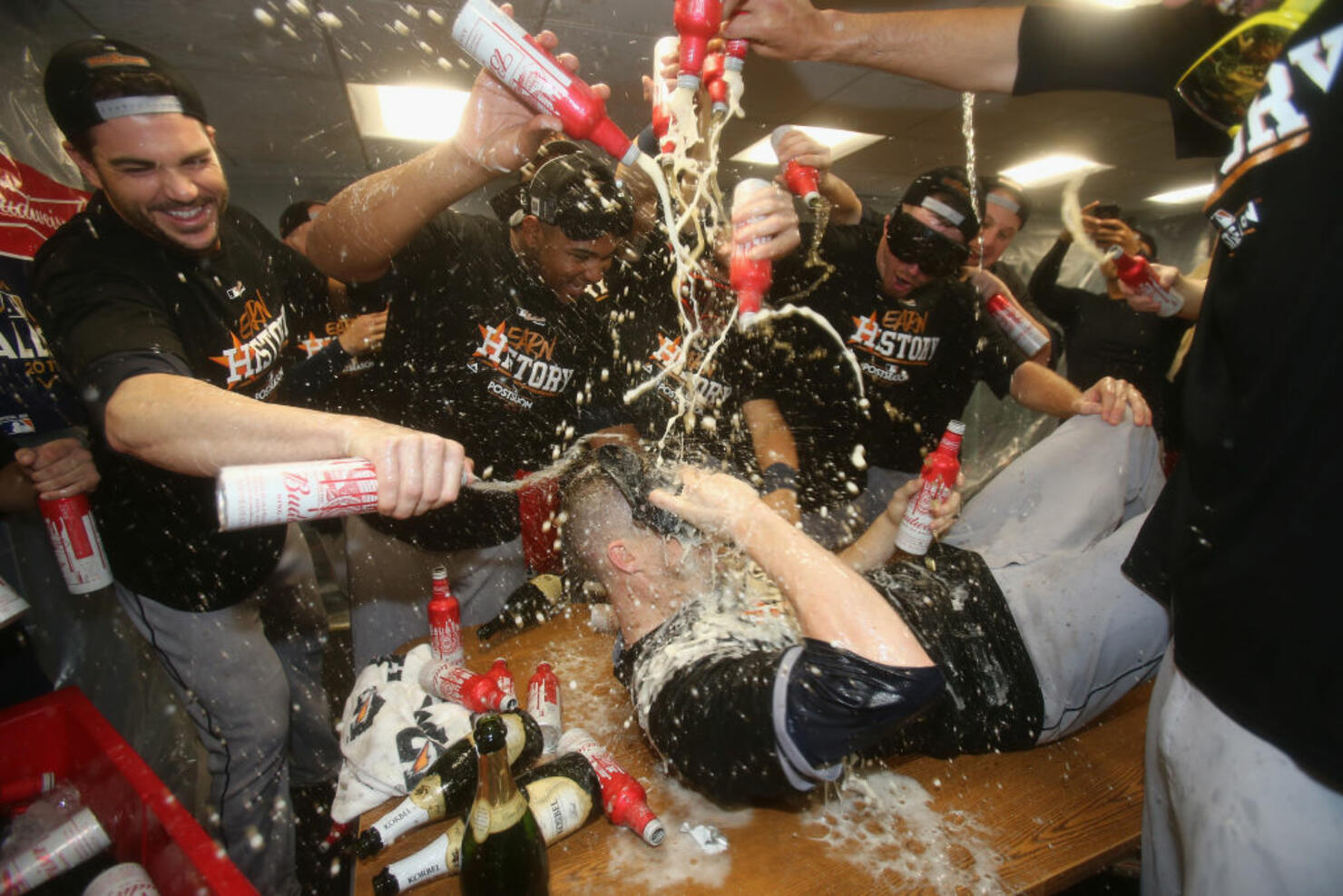Ken Giles #53 of the Houston Astros (on table) celebrates with teammates 