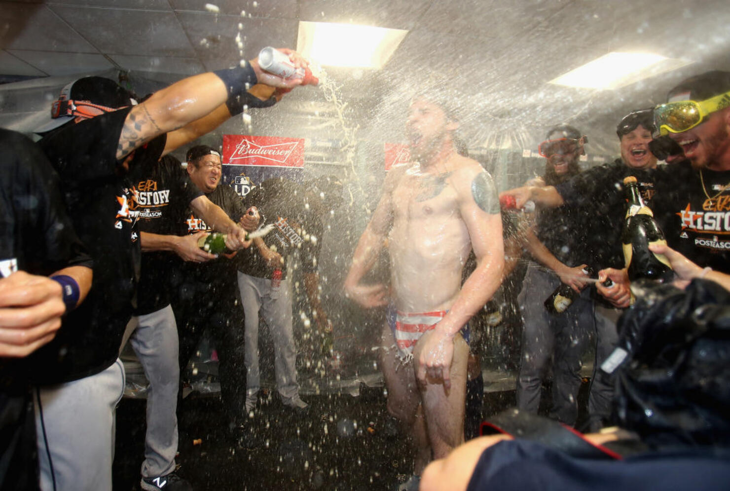 Josh Reddick #22 of the Houston Astros celebrates with teammates in the clubhouse