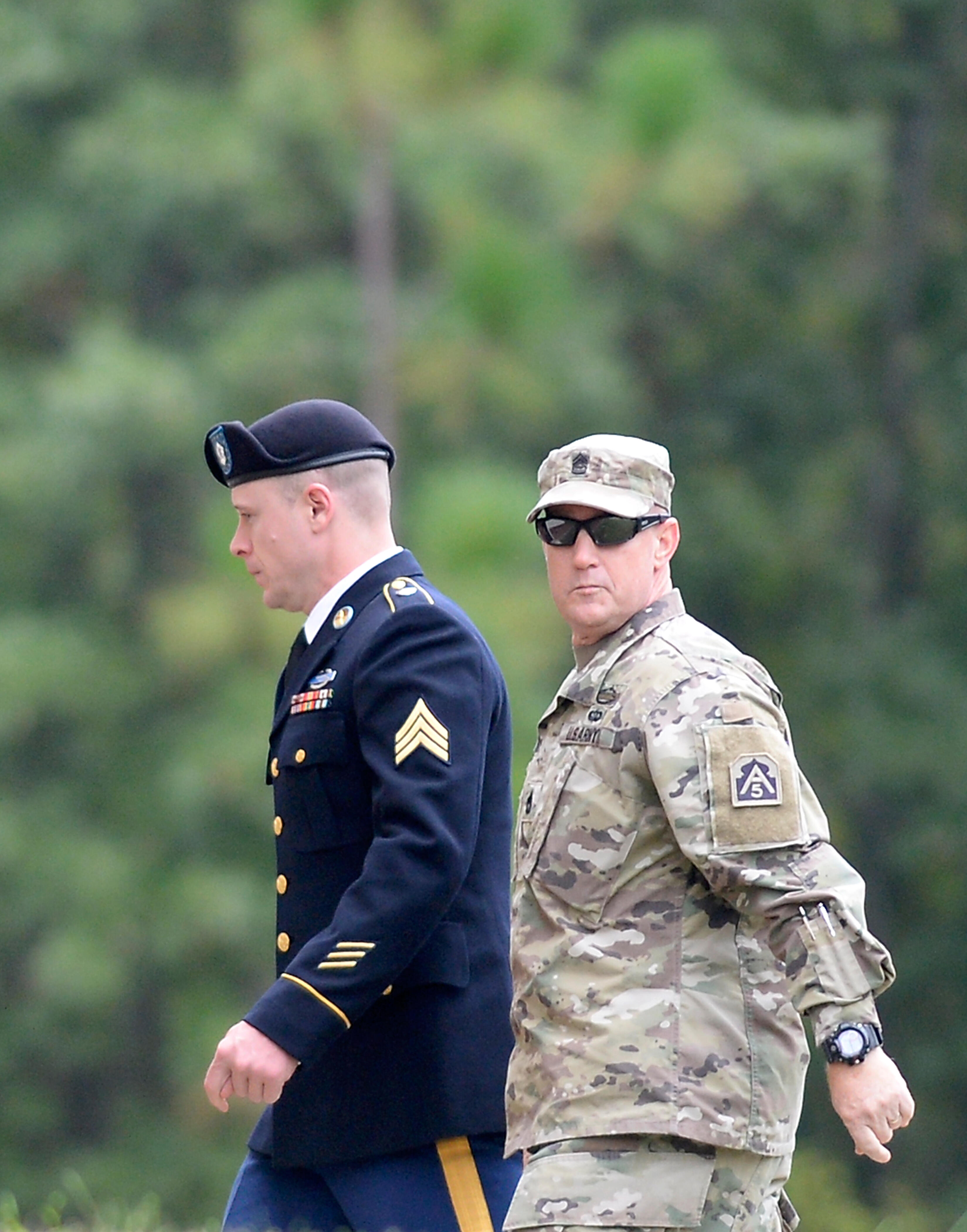 FORT BRAGG, NC - OCTOBER 16: U.S. Army Sgt. Robert Bowdrie 'Bowe' Bergdahl (L), 29 of Hailey, Idaho, is escorted into the Ft. Bragg military courthouse for a motion hearing on October 16, 2017, in Fort Bragg, North Carolina. Bergdahl faces charges of desertion and endangering troops stemming from his decision to leave his outpost in 2009, which landed him five years in Taliban captivity. (Photo by Sara D. Davis/Getty Images)