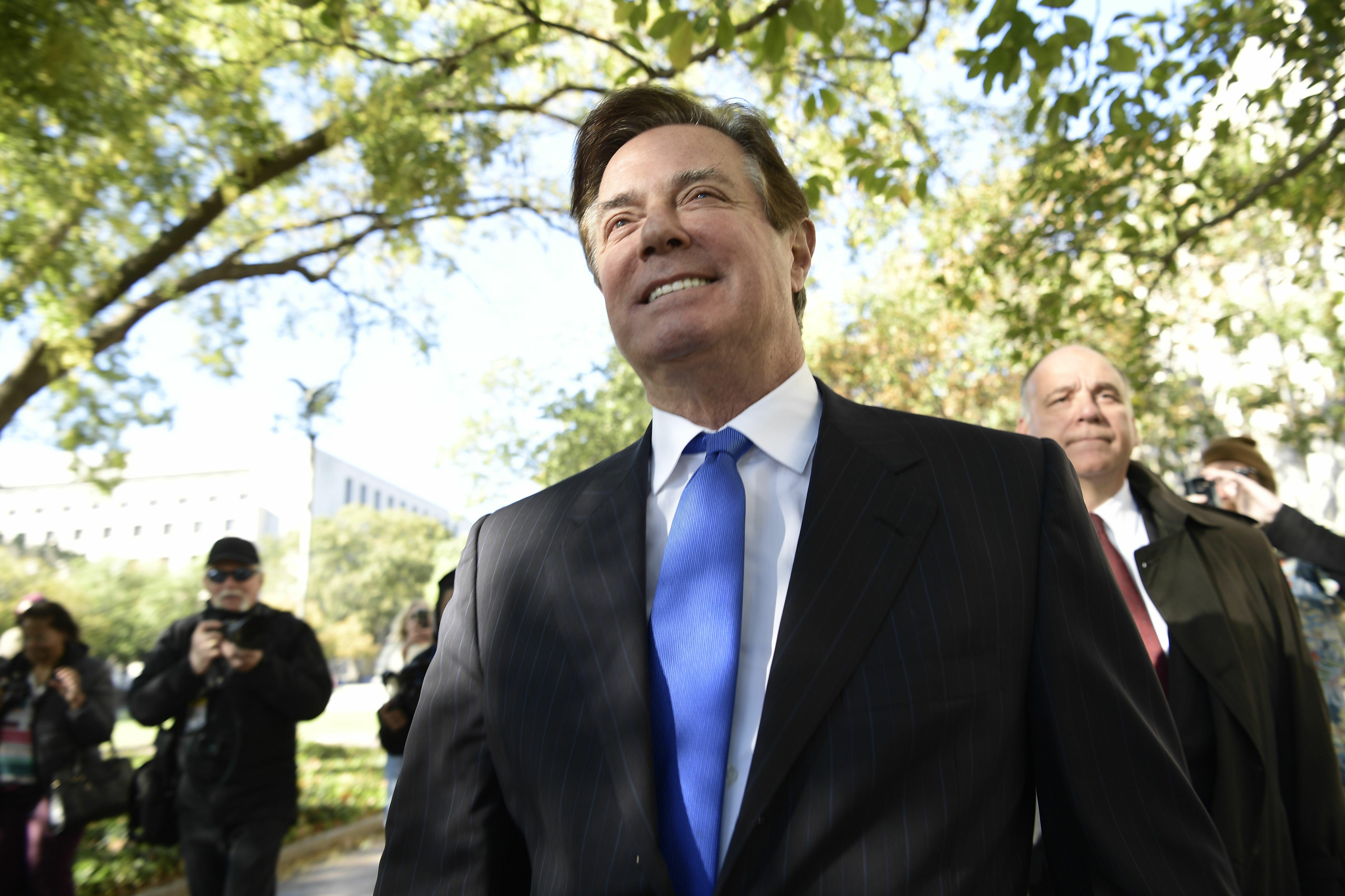 Paul Manafort walks outside the William B. Bryant US Courthouse Annex on October 30, 2017, in Washington, DC. President Donald Trump's former campaign chairman Paul Manafort pleaded not guilty Monday to charges of conspiracy and money laundering after the Justice Department unveiled the first indictments in the probe into Russian election interference. Manafort, 68, and business partner Rick Gates, 45, both entered not guilty pleas in a Washington court after being read charges that they hid millions of dollars they earned working for former Ukrainian politician Viktor Yanukovych and his pro-Moscow political party. / AFP PHOTO / Brendan Smialowski (Photo credit should read BRENDAN SMIALOWSKI/AFP/Getty Images)