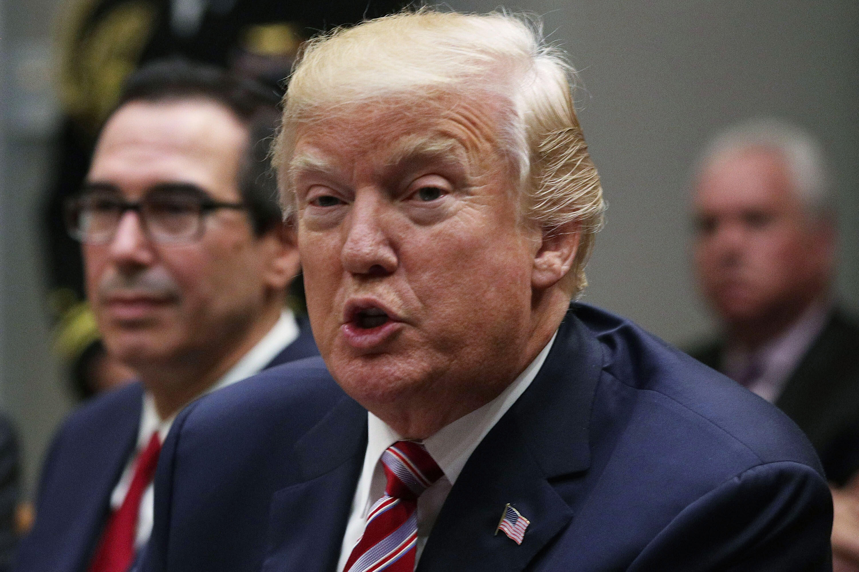 WASHINGTON, DC - OCTOBER 31: U.S. President Donald Trump (2nd L) speaks to business leaders as Secretary of the Treasury Steven Mnuchin (L) looks on during a Roosevelt Room event October 31, 2017, at the White House in Washington, DC. President Trump participated in a 'tax reform industry meeting.' (Photo by Alex Wong/Getty Images)