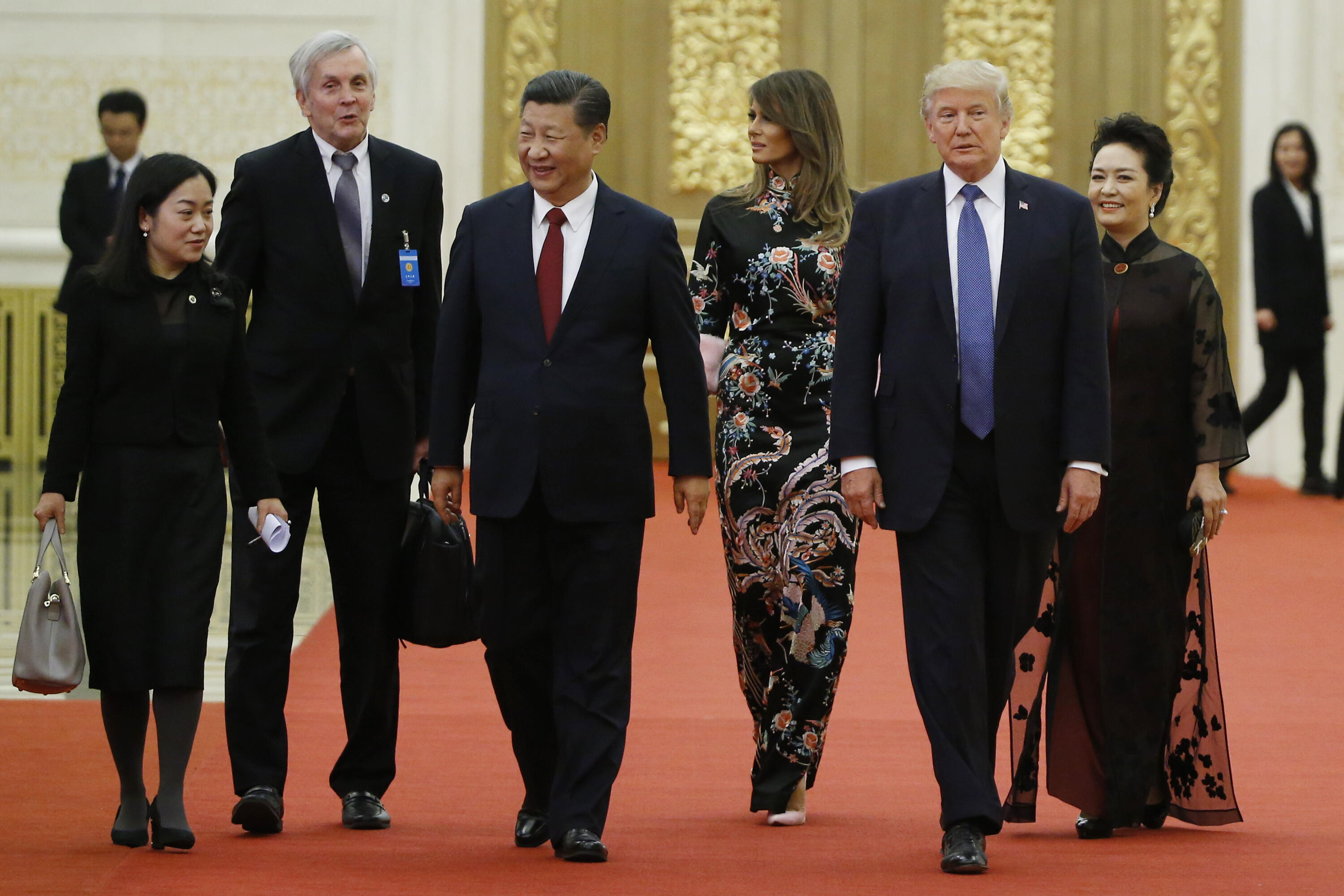 US President Donald Trump (2nd R) and First Lady Melania Trump (3rd R) arrive for a state dinner with China's President Xi Jinping (3rd L) and his wife Peng Liyuan (R) at the Great Hall of the People in Beijing on November 9, 2017. Donald Trump urged Chinese leader Xi Jinping to work hard and act fast to help resolve the North Korean nuclear crisis during talks in Beijing Thursday, warning that 'time is quickly running out'. / AFP PHOTO / POOL / THOMAS PETER (Photo credit should read THOMAS PETER/AFP/Getty Images)
