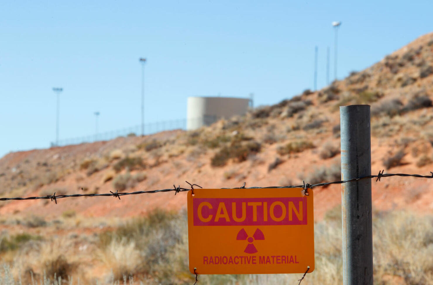 A radioactive warning sign hangs on fencing around the Anfield's Shootaring Canyon Uranium Mill on October 27, 2017.