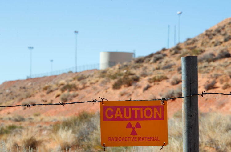A radioactive warning sign hangs on fencing around the Anfield's Shootaring Canyon Uranium Mill on October 27, 2017.