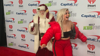 This Photo of Bebe Rexha Running From Santa Needs to Be Captioned 