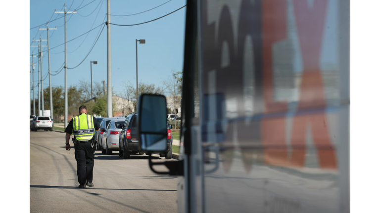 A police officer blocks a road outside a FedEx facility following an explosion 