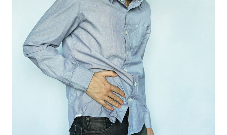 Guy holding his stomach getty images