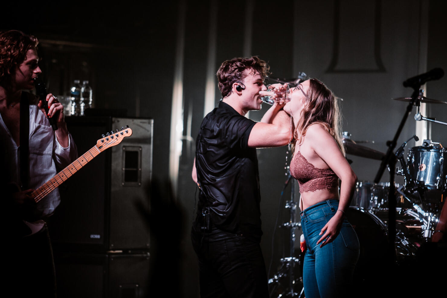 Ashton Irwin takes a shot with a fan for her birthday on stage at Irving Plaza