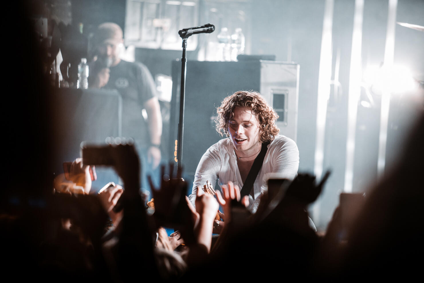 Luke Hemmings interacting with fans in the crowd at the intimate show