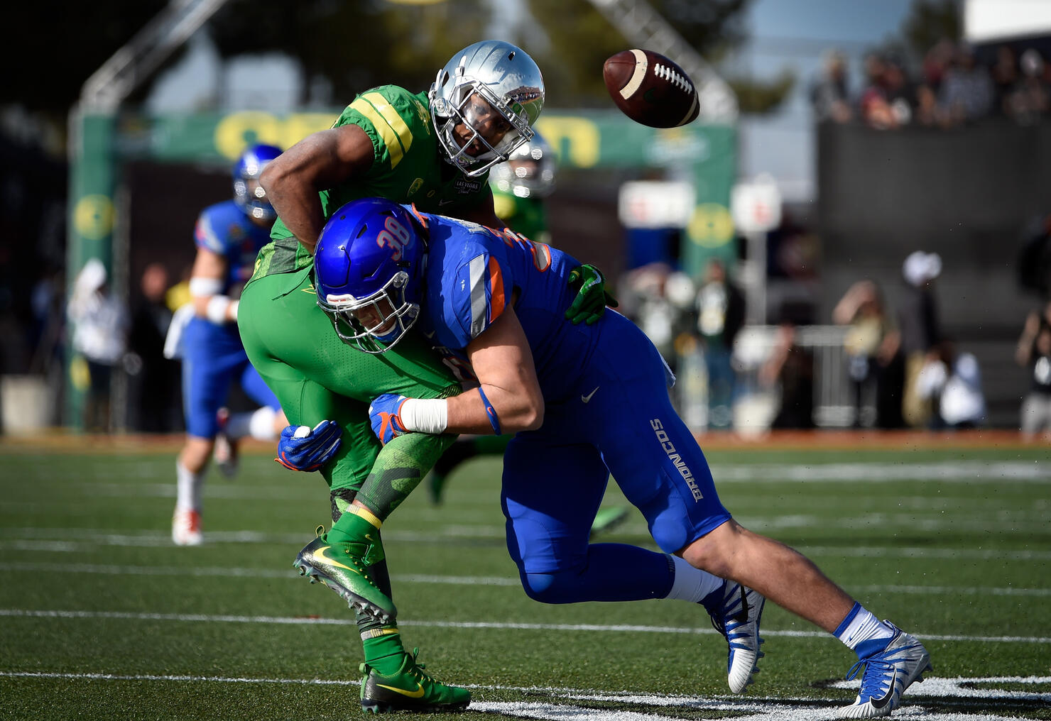 LAS VEGAS, NV - DECEMBER 16: Tony Brooks-James #20 of the Oregon Ducks fumbles the ball under pressure from Leighton Vander Esch #38 of the Boise State Broncos during the first half of the Las Vegas Bowl at Sam Boyd Stadium on December 16, 2017 in Las Vegas, Nevada. Boise State won 38-28. (Photo by David Becker/Getty Images)