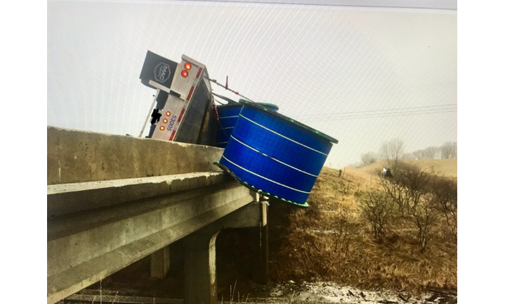 Semi tipped, load hanging over I-80 bridge near Newton, Iowa.  WHO TV