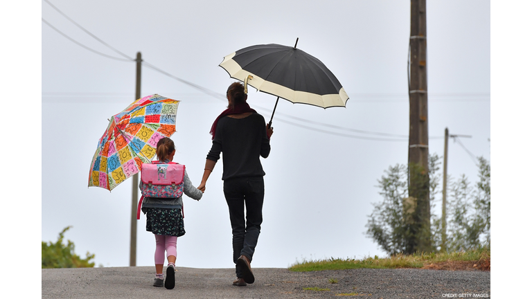 A girls walks to her primary school with her mother on the first day of the new school year in Vertou, western France, on September 4, 2017. / Photo credit: AFP PHOTO / LOIC VENANCE 