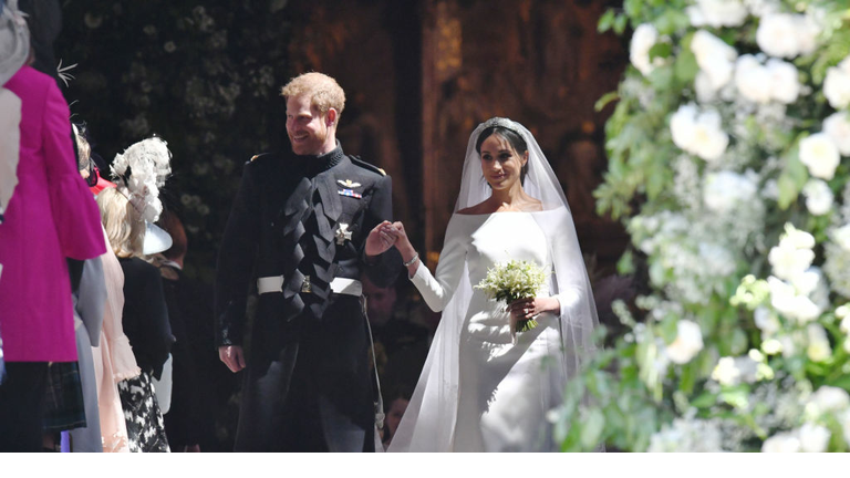 Prince Harry and Meghan Markle walk along the aisle of St George's Chapel